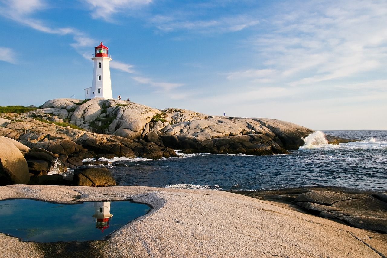 Lighthouse at dusk over calm water